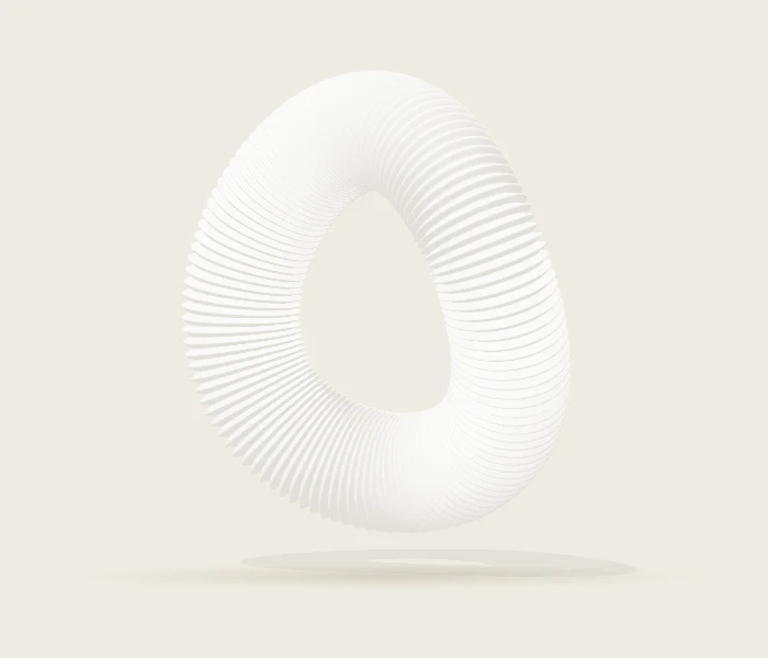 Soft white Orbit sculpture against a warm studio background